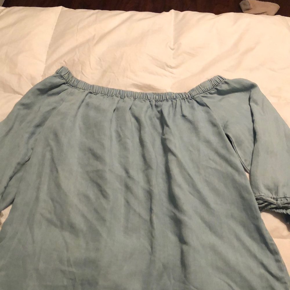 a denim blue off the shoulder shirt